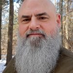 Troy Robinson is a native Kansan with a lifelong connection to the agrarian landscape and a strong solitary practice within Germanic Heathenry. With over nearly four decades of combined service between the U.S. Marine Corps, Corrections, and Law Enforcement, Troy has extensive experience designing curriculum, building training and policy manuals, and developing instructor certification programs. Presently Troy facilitates group therapies providing cognitive-behavioral interventions to enhance moral decision making and improve behavior through addressing risk, needs, and responsivity for justice-involved individuals. A strong supporter and student of Cherry Hill Seminary, Troy completed the Community Ministry Certificate and the Writing as Spiritual Practice programs. He is a member of the Votaries Alumni Association and serves on the Board of Directors. A member of Sacred Well Congregation, he is working towards ordination as a minister and cleric priest. Troy enjoys adventures with his wife, children, and grandchildren; exploring the less traveled, scenic backroads and educational opportunities available throughout the United States. A published author and artist, Troy uses his spare time to challenge his creativity to craft within a variety of mediums.